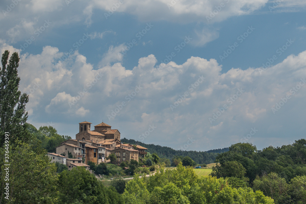 Panorama of a village Sant Jaume de Frontanya with church visible in the middle. Beautiful catholic church in the middle of catalunyan or spanish countryside on a sunny day. Panorama of a village Sant Jaume de Frontanya with church visible in the middle. Beautiful catholic church in the middle of catalunyan or spanish countryside on a sunny day.