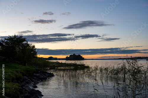 sunrise over the lake when the sky is covered with rain clouds