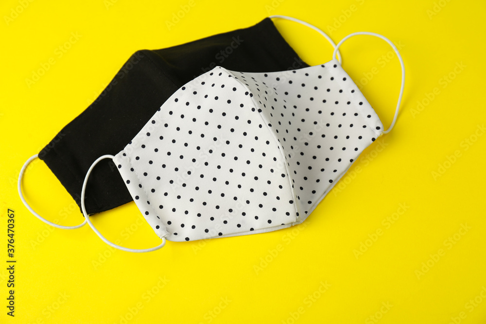 Homemade protective face masks on yellow background Homemade protective face masks on yellow background