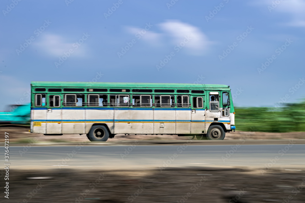 Motion blur image of non air-conditioned intercity bus in Maharashtra.