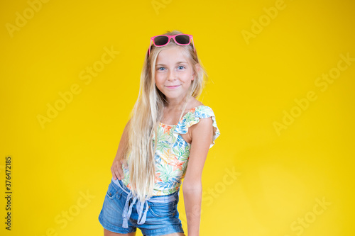Smiling blonde girl posing in summer clothes