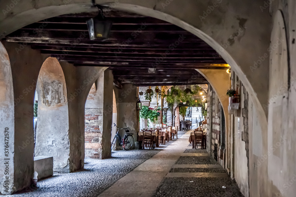 Street restaurant in the gallery in Verona. Veneto, Italy