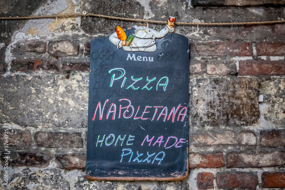 Fototapeta premium Street menu with the name of the main dish of the pizzeria. Verona, Italy
