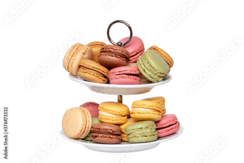 Macaron isolated. Close-up of colourful French macaroons on a two-storey etagere isolated on a white background. Pastries, desserts and sweets. Macro. photo