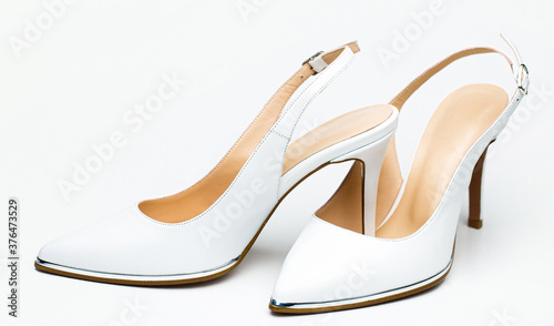Stylish classic women leather shoe. White high heel women shoes on white background
