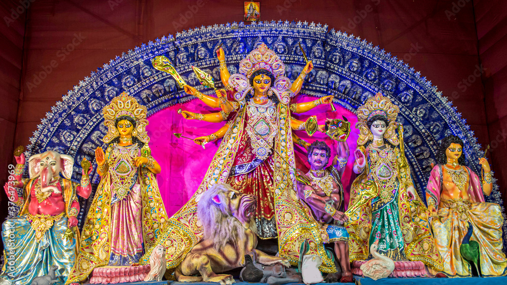 Fototapeta premium Durga Puja or Durgotsava,is an annual Hindu festival celebrated mainly in West Bengal,Indian.Durga is Goddess riding a lion with many arms each carrying weapon and defeating evil power of Mahishasura.