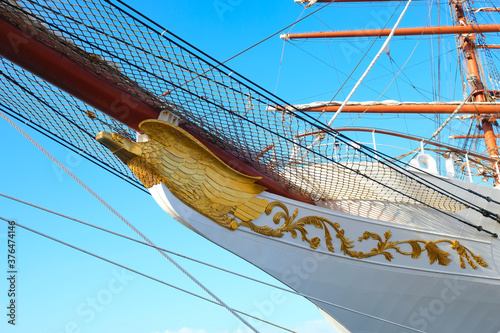 Fényképezés Detail of a classic sailing ship, a golden figurehead and badge.