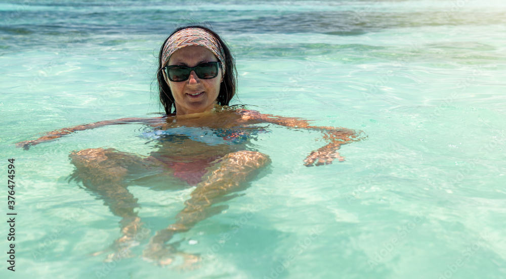 Beautiful woman relaxing in the water, Seychelles Islands