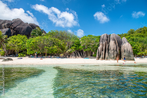 LA DIGUE, SEYCHELLES - SEPTEMBER 11, 2017: Tourists relax on the beautiful Source Argent Beach on a sunny day
