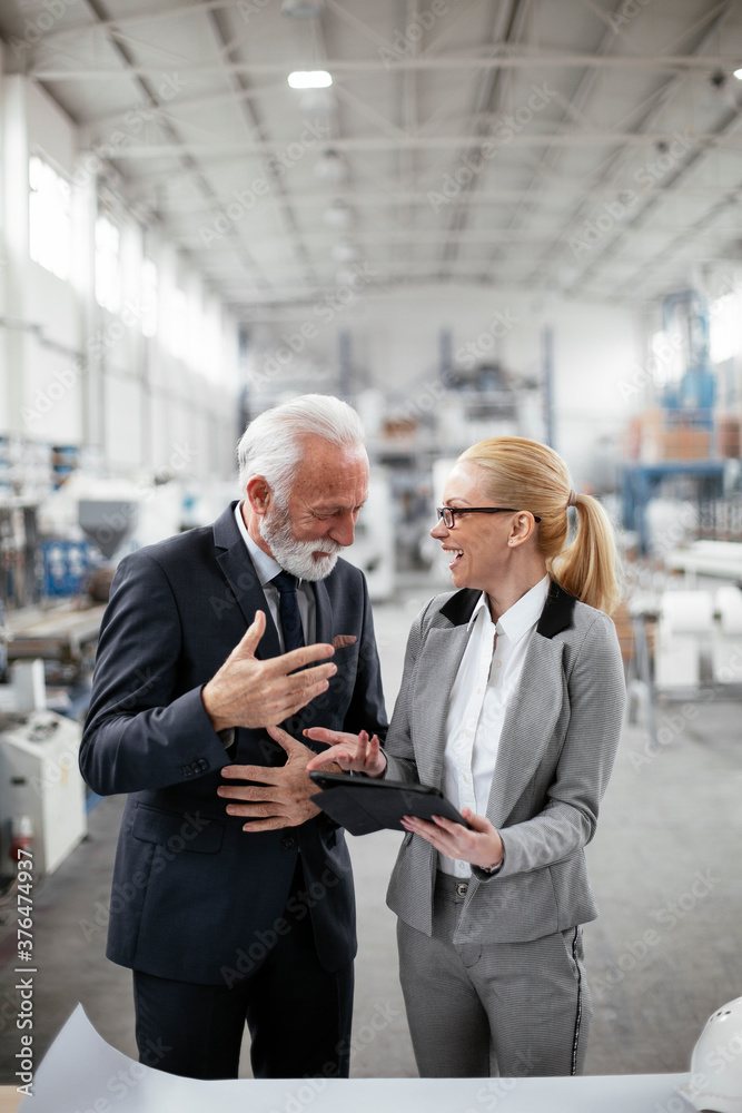 Man and woman discussing work. Colleagues working in factory. Man and woman discussing work. Colleagues working in factory.