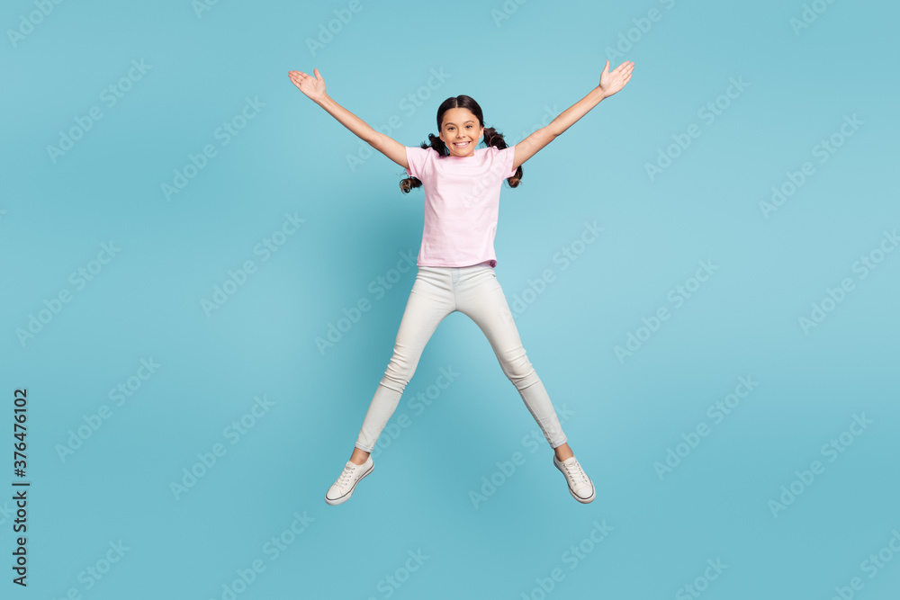 Full length body size view of her she nice attractive pretty lovely cute glad successful cheerful cheery pre-teen girl jumping having fun free time leisure isolated over blue pastel color background