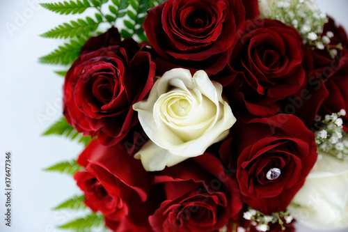 Pure white and crimson red roses bouquet for the wedding day  Valentine s day or an anniversary  concept or ideas for floral arrangement for the bride s or bridesmaids  bouquets or florist inspiration