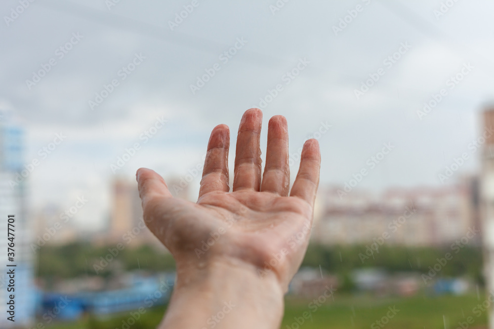 Palm hands with water splash. Nature rain drop, environmental and freshness concept.Girl holding out her hands to the rain. Palm hands with water splash. Nature rain drop, environmental and freshness concept.Girl holding out her hands to the rain.