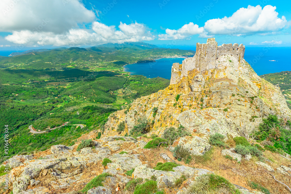Iconic view from top of Elba mountain of Volterraio Castle on rock at 394 m, Fortress of Volterraio, symbol of Elba Island, dominates Portoferraio Gulf, Tuscan Archipelago, Tuscany Iconic view from top of Elba mountain of Volterraio Castle on rock at 394 m, Fortress of Volterraio, symbol of Elba Island, dominates Portoferraio Gulf, Tuscan Archipelago, Tuscany