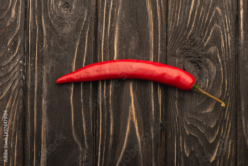 top view of spicy red chili pepper on wooden surface
