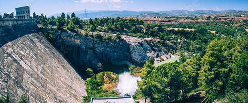 Panorama picture of a dam of hydroelectric power plant of Talarn, on the Talarn lake, close to the Tremp city in Catalunya, Spain on a sunny day. photo