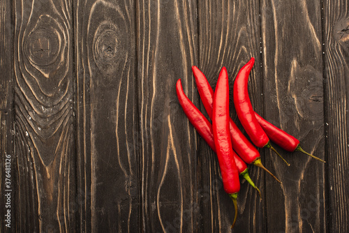 top view of chili peppers on wooden surface