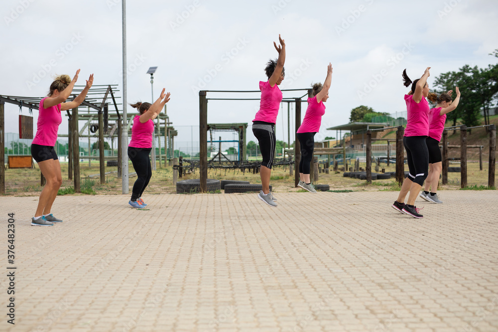 custom made wallpaper toronto digitalGroup of woman performing jumping jacks exercise at boot camp