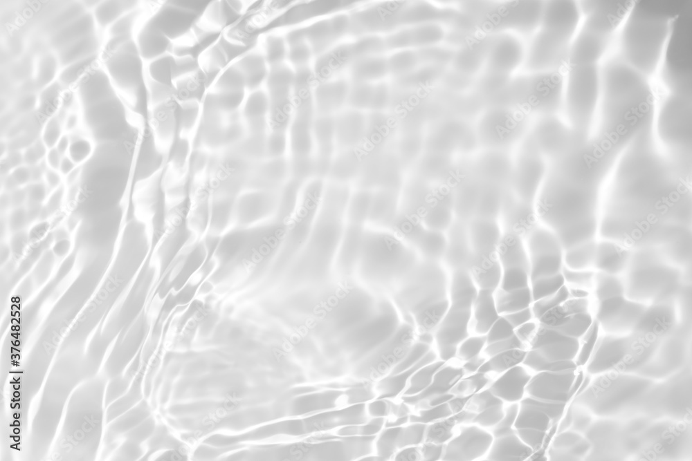 Blurred desaturated transparent clear calm water surface texture with splashes and bubbles. Trendy abstract nature background. White-grey water waves in sunlight. Copy space. - obrazy, fototapety, plakaty 