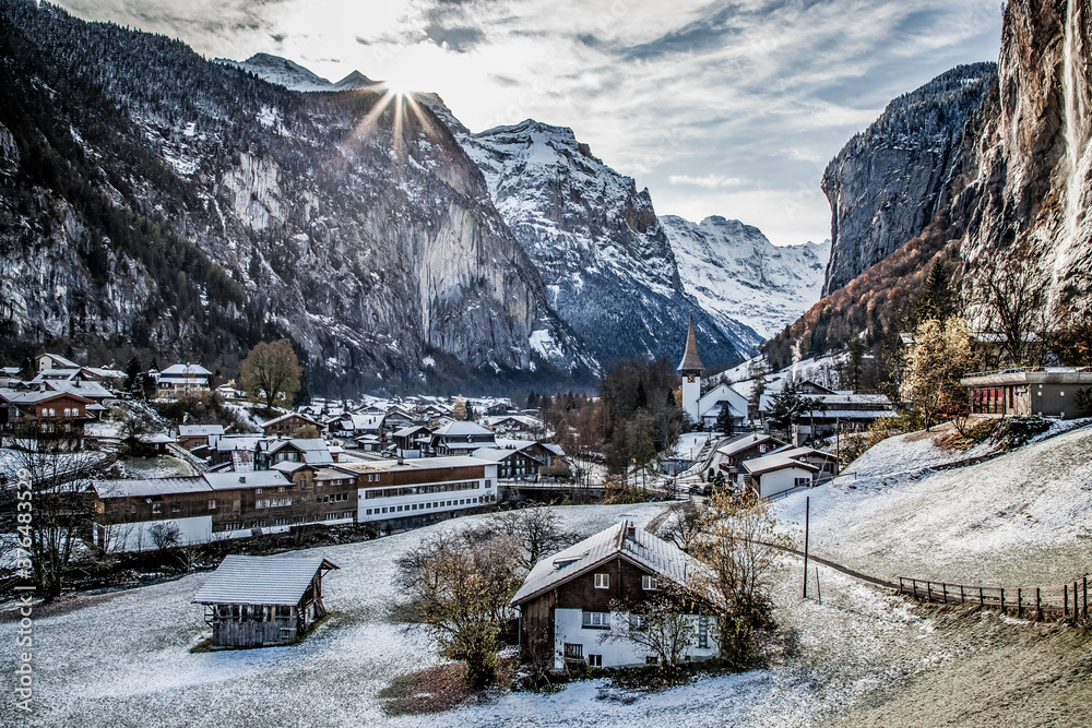 amazing touristic alpine village in winter with famous church and Staubbach waterfall  Lauterbrunnen  Switzerland  Europe