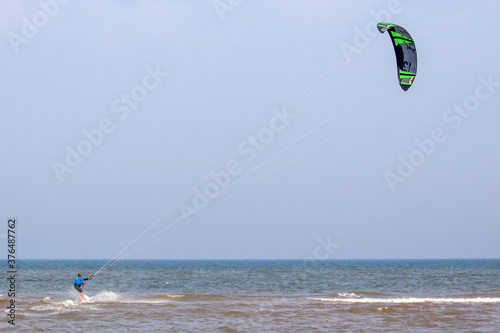 Kite surfer at sea near the beach of Noordwijk.