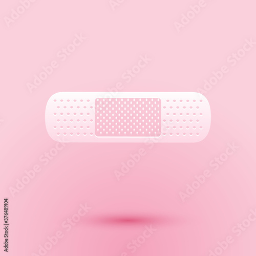 Paper cut Bandage plaster icon isolated on pink background. Medical plaster, adhesive bandage, flexible fabric bandage. Paper art style. Vector.