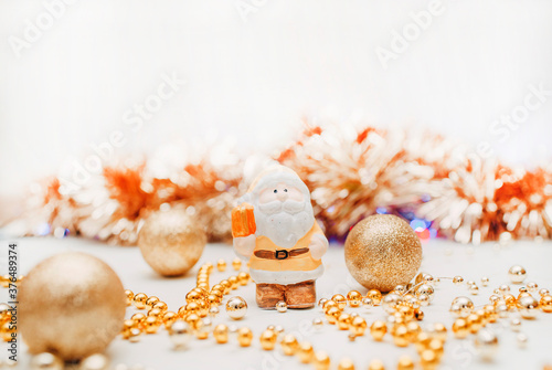 concept of coming Christmas and New Year presented by holiday ornamants and toys in gold colors photo