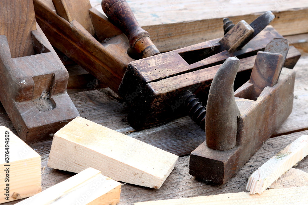 Old wooden carpenter's planes on a wooden background. Still life with old carpenter's planes Old wooden carpenter's planes on a wooden background. Still life with old carpenter's planes