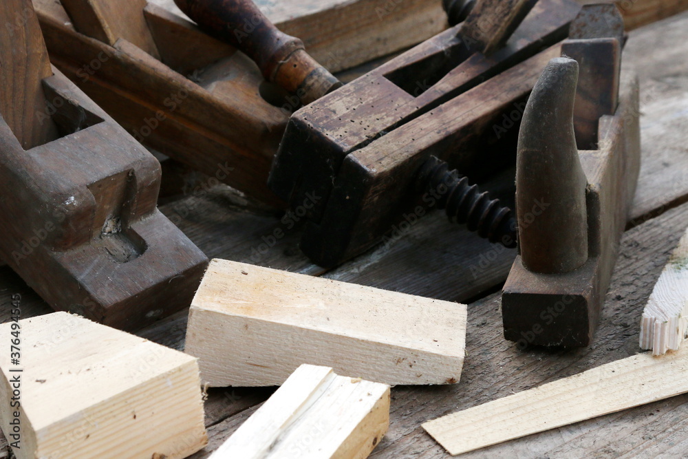Old wooden carpenter's planes on a wooden background. Still life with old carpenter's planes Old wooden carpenter's planes on a wooden background. Still life with old carpenter's planes