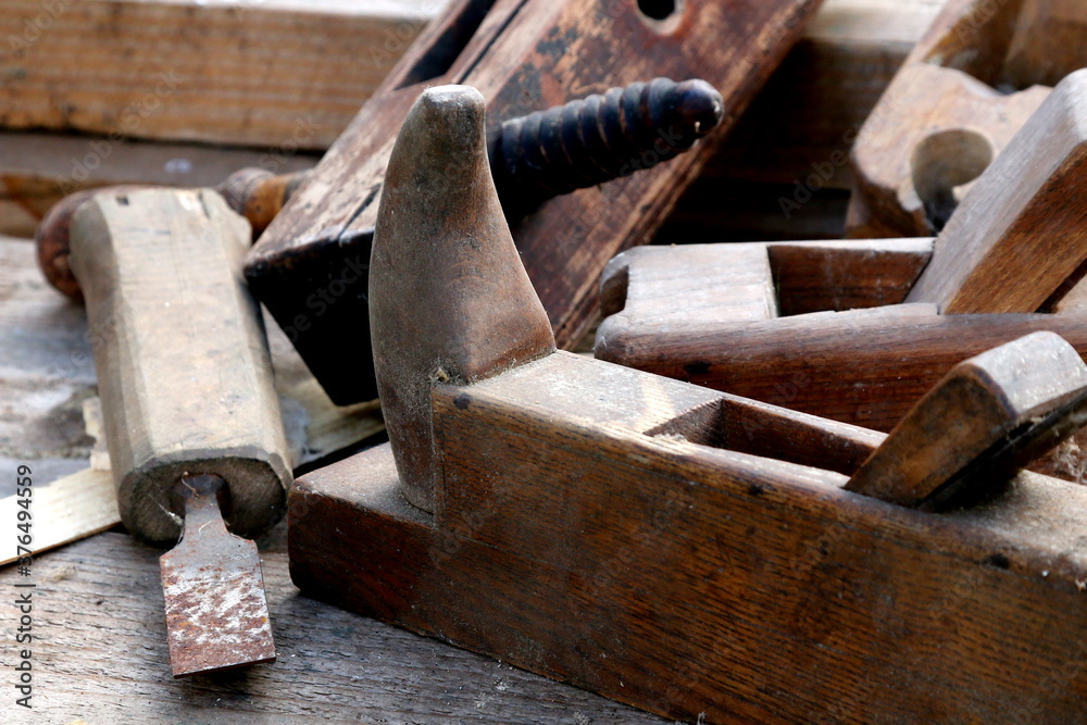 Old wooden carpenter's planes on a wooden background. Still life with old carpenter's planes Old wooden carpenter's planes on a wooden background. Still life with old carpenter's planes