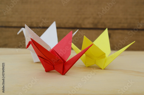 folded paper cranes on wooden