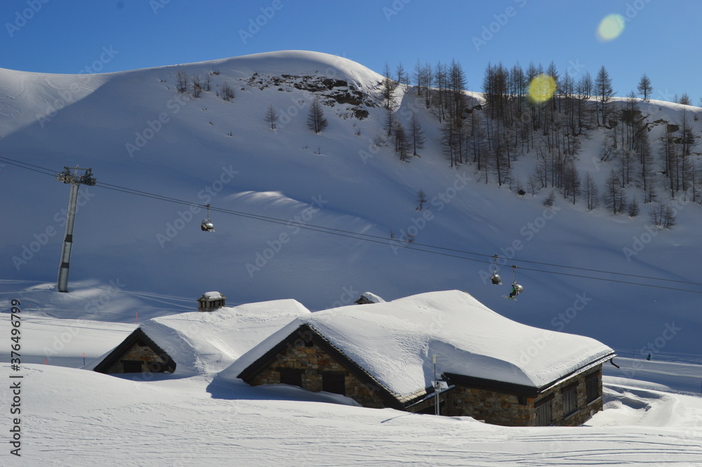 Skiing in the snow covered mountains of the San Domenico Ski Resort in Alps in Northern Italy Skiing in the snow covered mountains of the San Domenico Ski Resort in Alps in Northern Italy