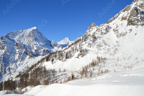 Skiing in the snow covered mountains of the San Domenico Ski Resort in Alps in Northern Italy