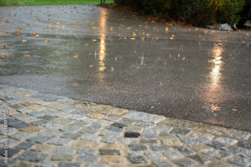 flooded road during heavy rain. raindrops splashes background.
