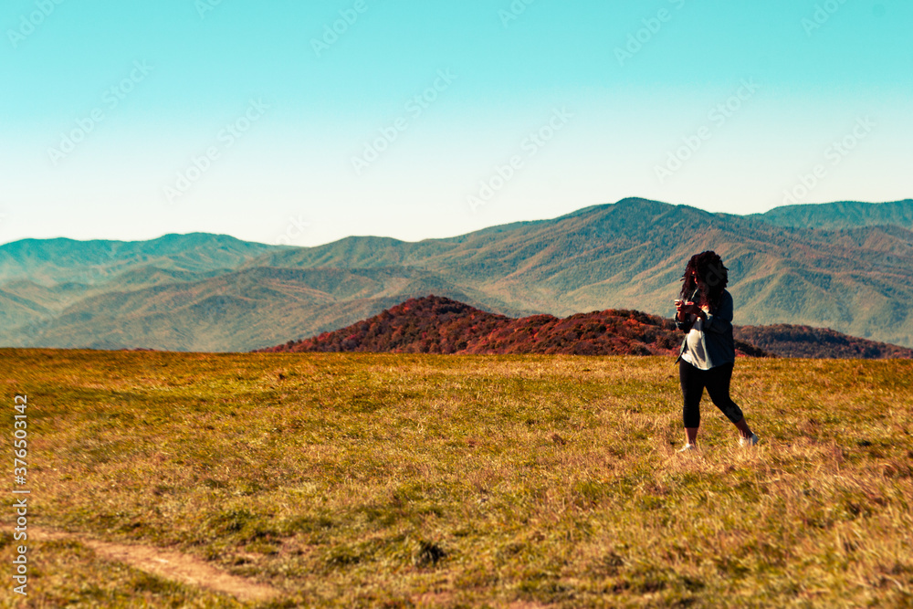 Woman Hiking and Texting on a Bald Mountain Woman Hiking and Texting on a Bald Mountain