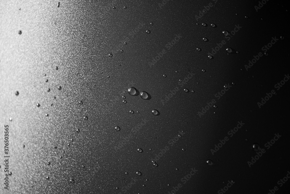 Water drops on plastic black surface as texture