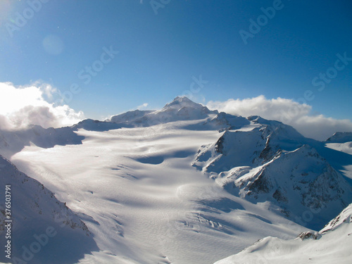 Walking through the snow-capped white mountains in a sunny day