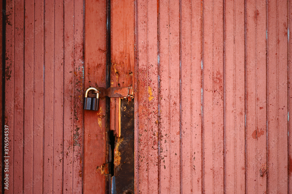 red door with planks on the lock close-up. red door with planks on the lock close-up.