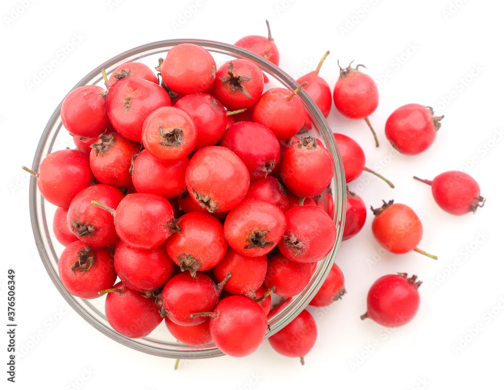 Hawthorn in a glass plate and scattered on a white. Top view. Hawthorn in a glass plate and scattered on a white. Top view.