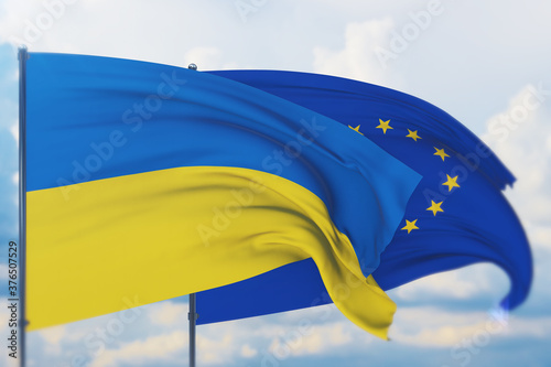 Waving European Union flag and flag of Ukraine. Closeup view, 3D illustration.