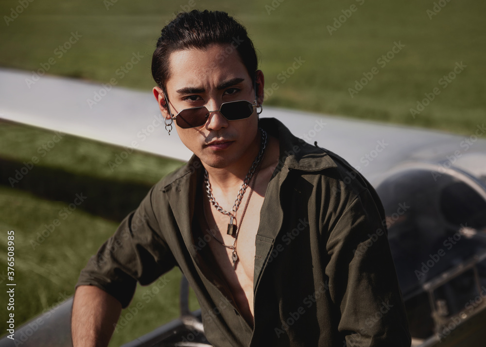 guy in uniform and sunglasses sits near the plane guy in uniform and sunglasses sits near the plane
