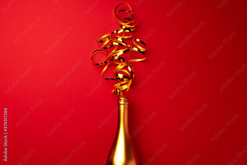 Champagne bottle with streamers flat lay top view