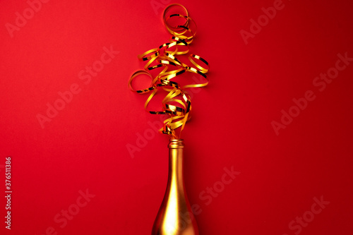 Champagne bottle with streamers flat lay top view
