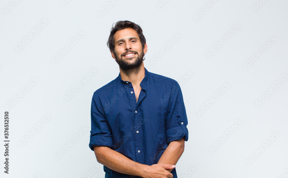 young latin handsome man looking happy, cheerful and confident, smiling proudly and looking to side with both hands on hips - obrazy, fototapety, plakaty 