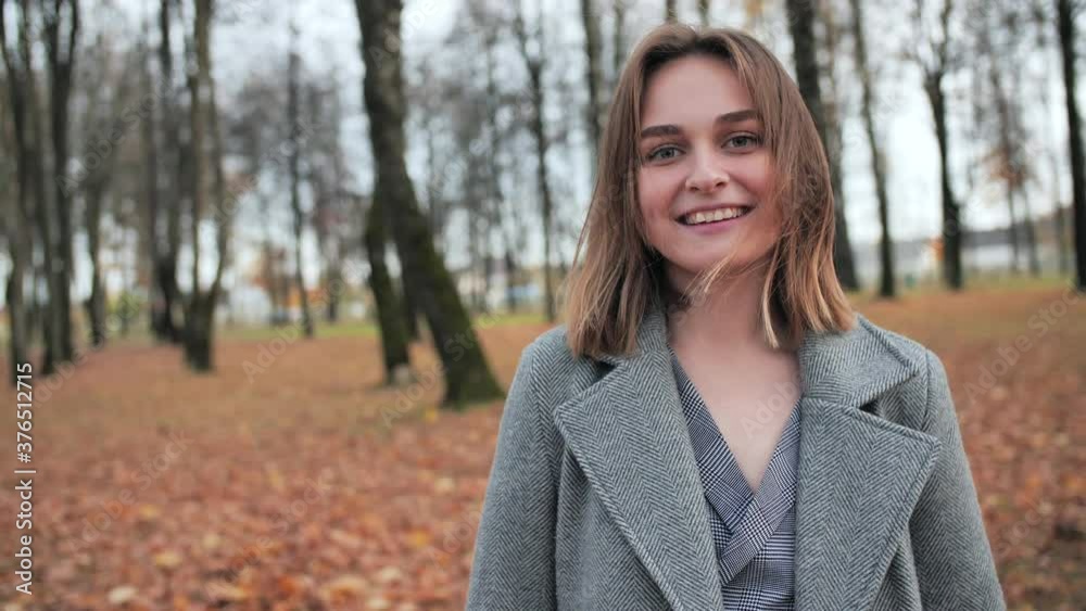 A beautiful and happy girl is walking in the autumn park. A beautiful and happy girl is walking in the autumn park.