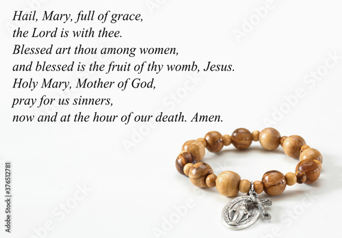 Slika na platnu Rosary bracelet on white with Hail Mary text.