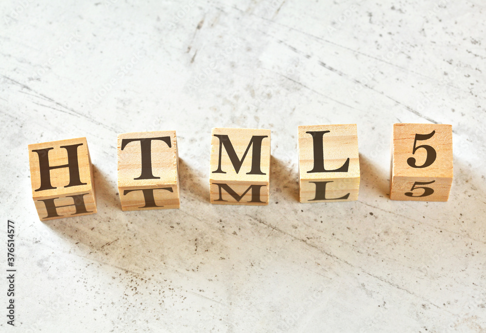 Five wooden cubes with word HTML5 on white stone like board, view from above