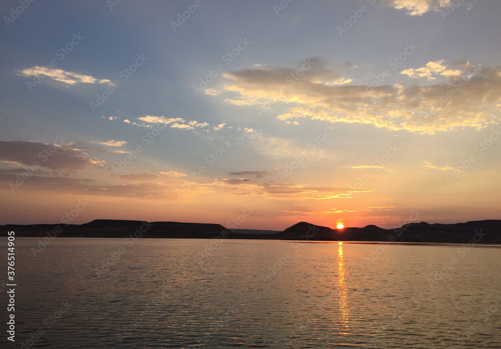 Peaceful evening Sunset reflecting across calm lake