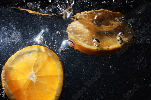 Water drops on ripe sweet orange. Fresh mandarin background with copy space for your text. Vegetarian concept. photo