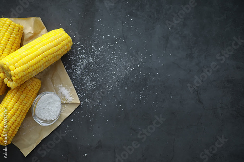 Freshly made fragrant ear of corn with salt. Farm snack of fresh corn. Healthy breakfast and healthy lifestyle concept.